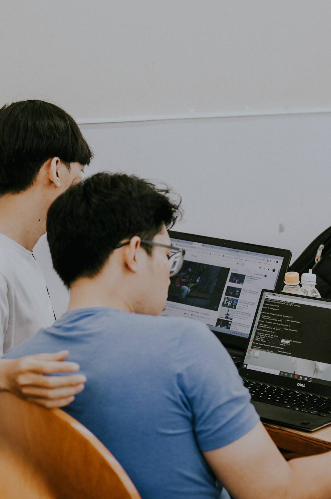 mentor teaching coding to student