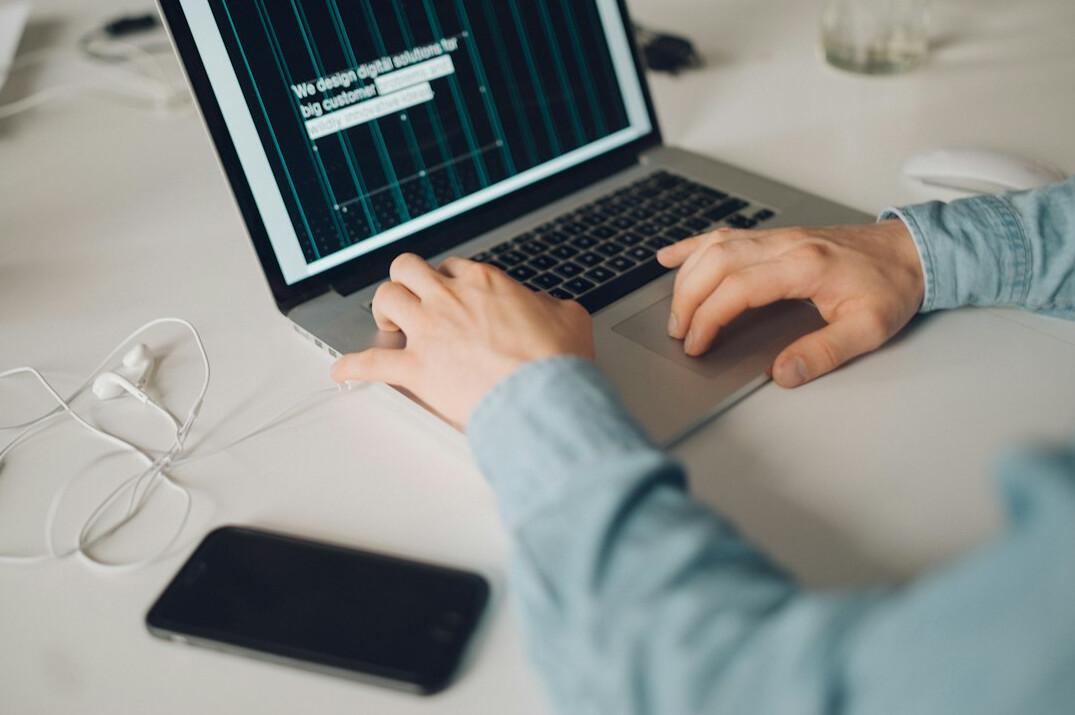 Person typing on a laptop at a desk