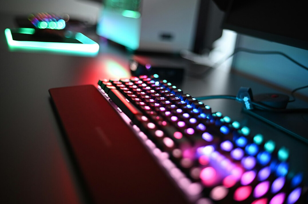 Desk with monitor, keyboard and code on the screen