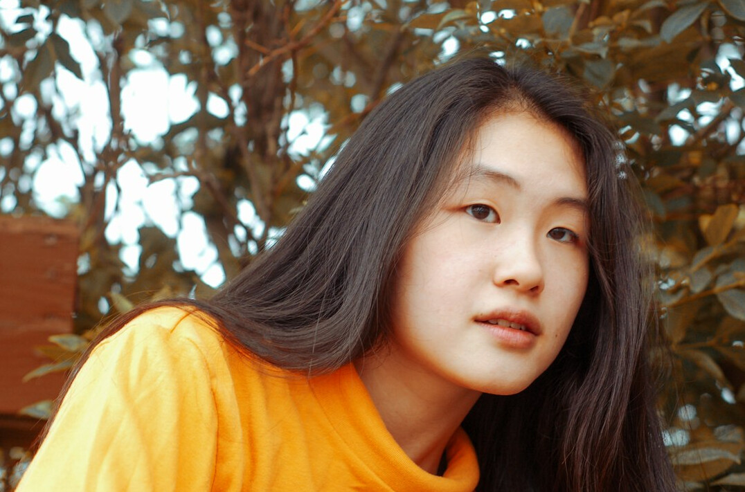 Portrait of a young woman with long hair smiling