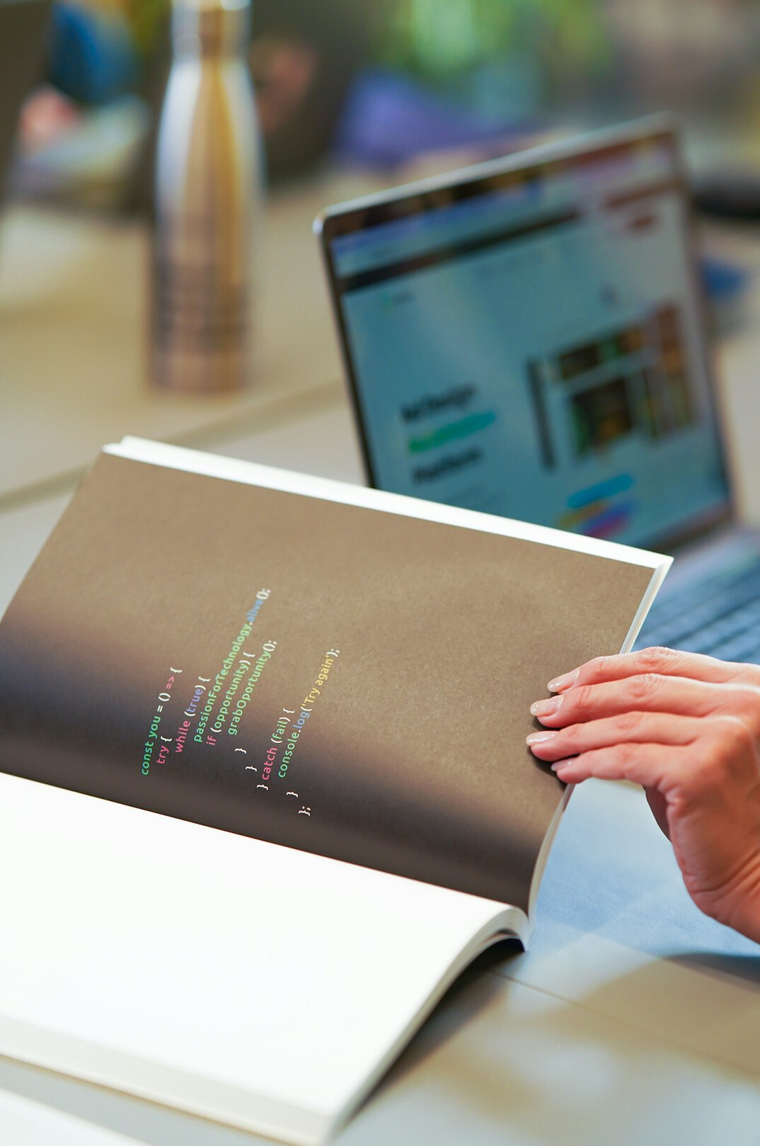person coding on laptop in office
